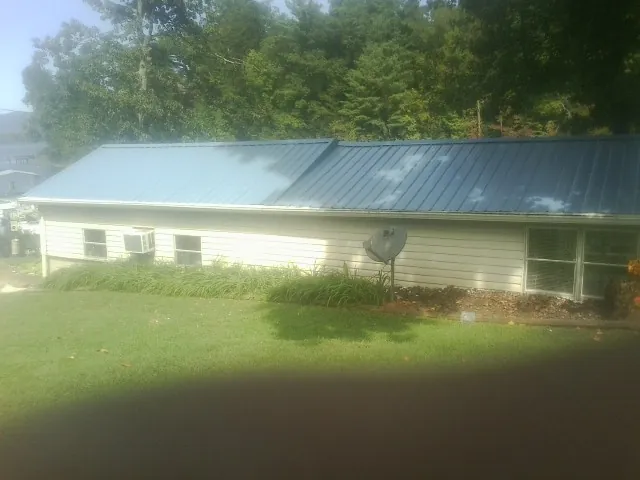 Blue metal roof running the length of a single story home in Jellico