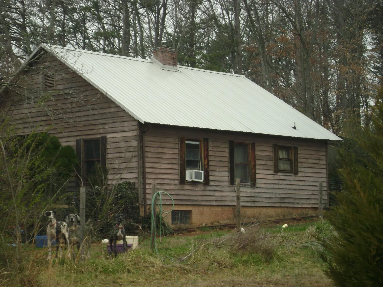 White metal roof on an old wood sided farmhouse, from a Metal Roof Installation job in Jellico